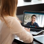 Businesswoman having distant negotiations using video conference application on pc